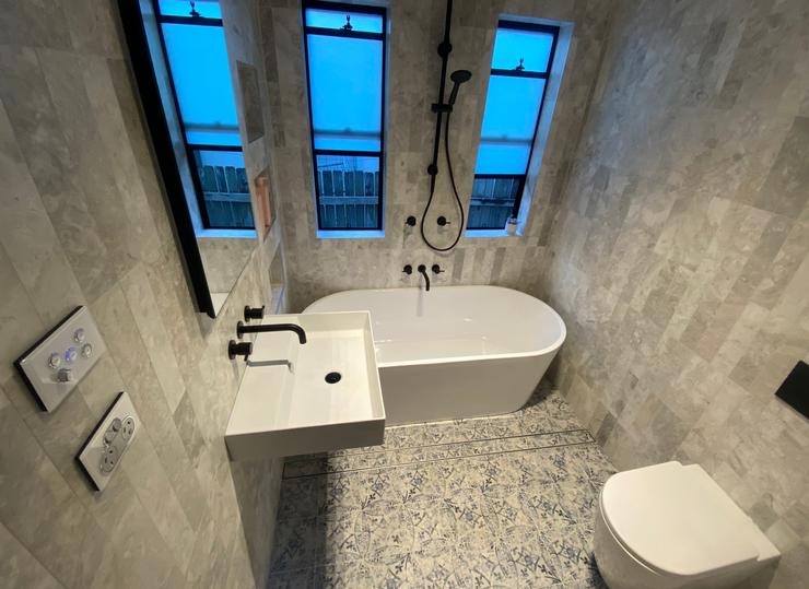 Free standing bath with stone tiling Sydney